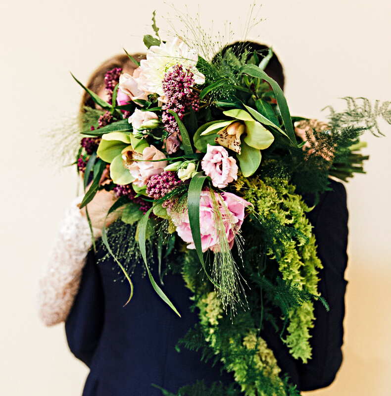 Green and pink garden cascade bridal bouquet with hanging amaranthus, orchids, and peonies.