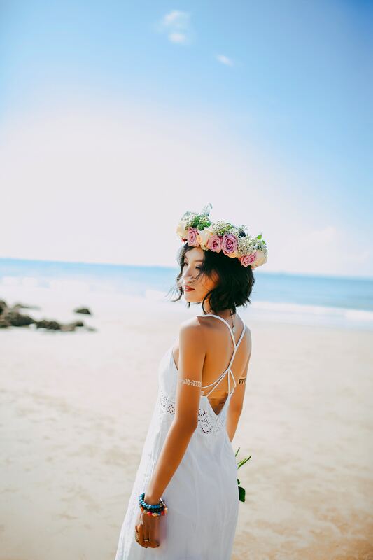 Pink and white bridal flower crown of roses and peonies at the beach.